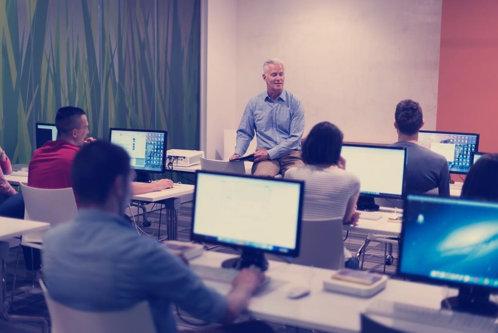 teacher and students in computer lab classroom